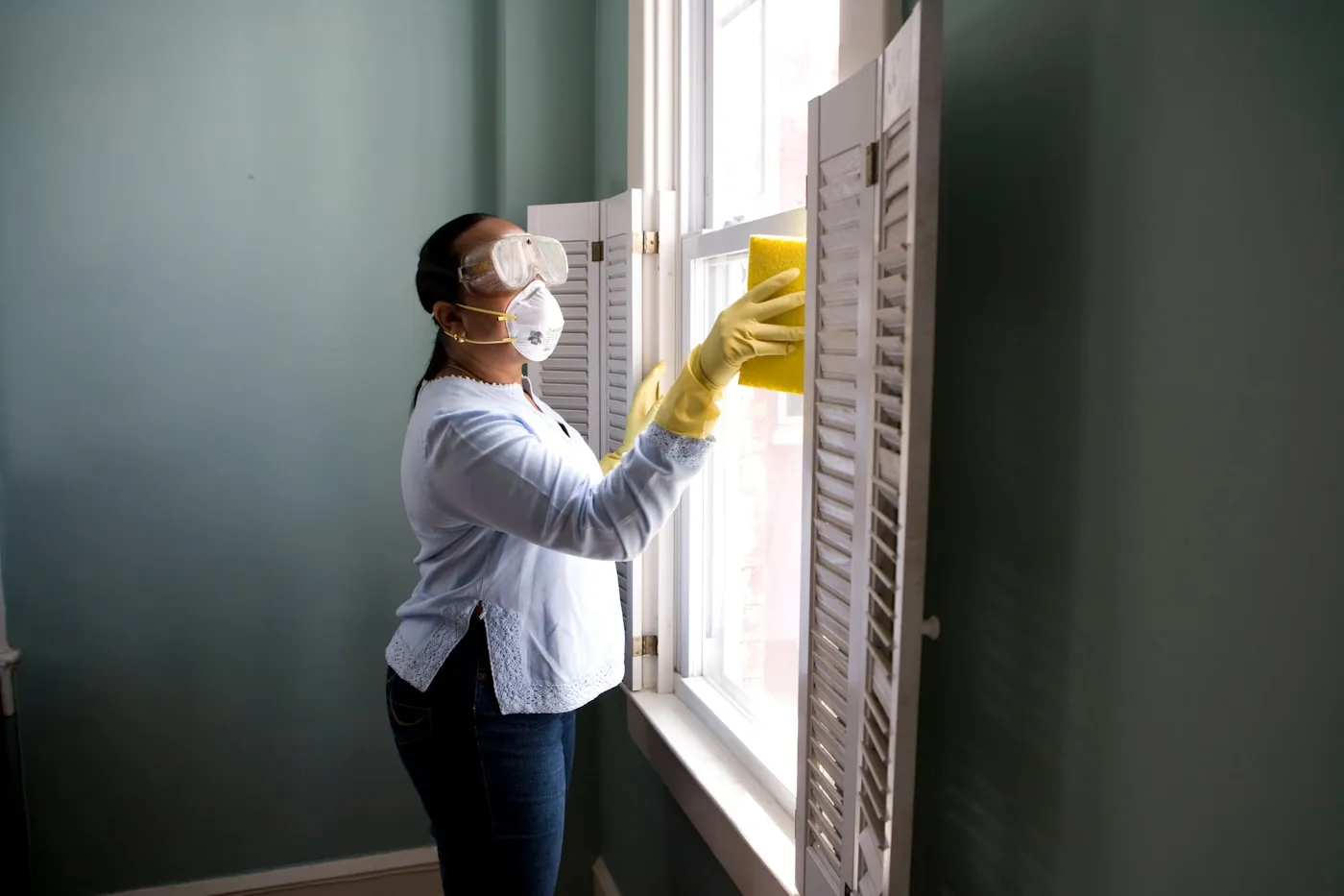A PestPro technician inspecting the exterior of a Central Texas home